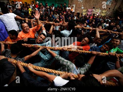 Nepalese Hindu Devotees Pull An Ancient Chariot Containing Depictions ...