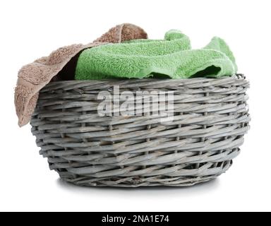 Wicker basket with towels isolated on white Stock Photo
