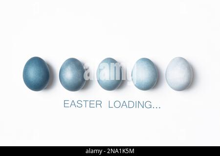 Dyed Easter eggs color gradient as loading bar. Easter is coming concept. Text Easter Loading on white, minimal style. Stock Photo