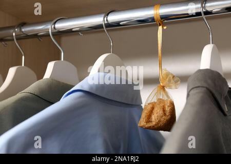 Scented sachet with flowers and stylish clothes on hanger Stock Photo -  Alamy