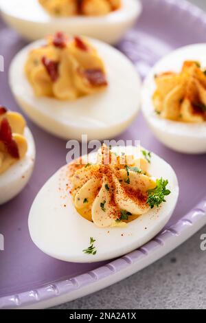 Deviled eggs with bacon and smoked paprika for Easter brunch Stock Photo
