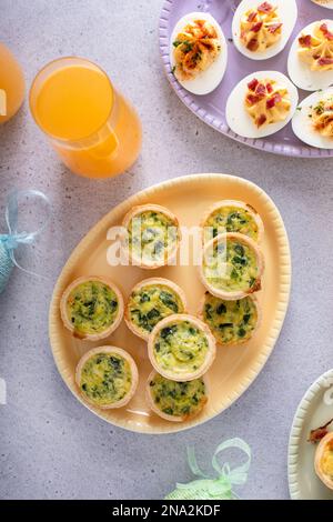 Mini quiches with spinach for Easter brunch, quiche florentine top view Stock Photo