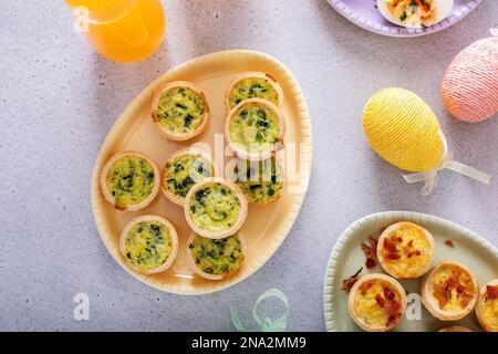 Mini quiches with spinach for Easter brunch, quiche florentine top view Stock Photo