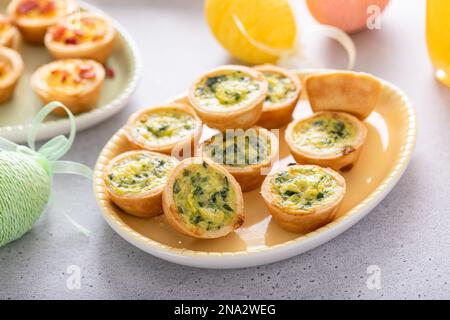 Mini quiches with spinach for Easter brunch, quiche florentine Stock Photo