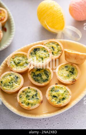 Mini quiches with spinach for Easter brunch, quiche florentine Stock Photo