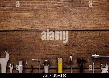 Flat lay with various work tools on wooden background working table. Top view on new hand tool set for repair, construction kit, overhead. Must-have for men. Equipment for building. Industry concept Stock Photo