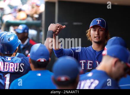 Texas Rangers' Elvis Andrus gives a thumbs-up to teammate during a practice  for baseballs's World Series, Sunday, Oct. 24, 2010, in Arlington, Texas.  The Rangers are scheduled to play the San Francisco