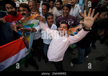 Cricket fans hold posters of the Indian cricket team before burning them,  as they shout protest slogans in New Delhi, India, Saturday, March 24,  2007. Disappointed fans burned posters of Indian players