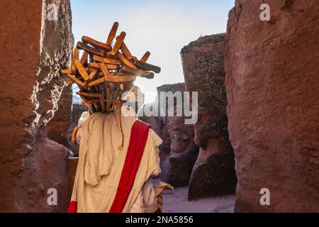 Ethiopian Orthodox priest carrying prayer sticks by Biete Qeddus Mercoreus (House of Saint Mercurius or House of Mark the Evangelist) Ethiopian Orthod Stock Photo