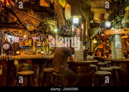 Man using his phone at Joe's Beerhouse; Windhoek, Namibia Stock Photo