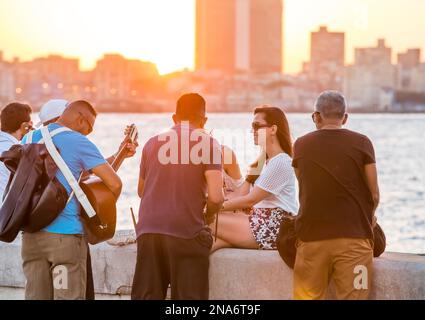 Musicians serenade tourists on the Malecon boardwalk in Havana, Cuba; Havana, Havana, Cuba Stock Photo