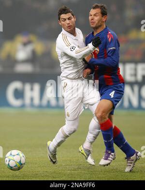 Real Madrid's Cristiano Ronaldo, white jersey, battles for the ball with  China's club team Guangzhou Evergrande's Feng Xiaoting during a friendly  match in Guangzhou, southern China's Guangdong province Wednesday, Aug. 3,  2011. (