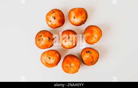 Sweet muffin cup cakes closeup on white background. Homemade pastry. Stock Photo