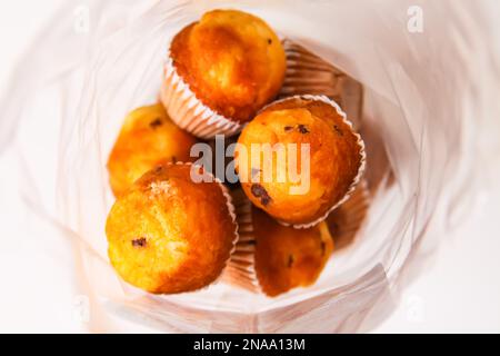 Sweet muffin cup cakes closeup on white background. Homemade pastry. Stock Photo