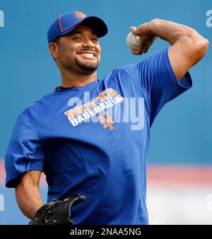 Pitcher Johan Santana wears his new cap and jersey during a news