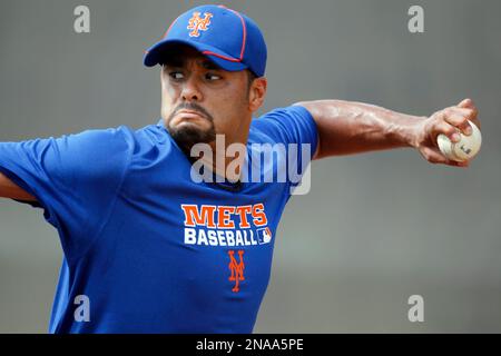 Pitcher Johan Santana wears his new cap and jersey during a news