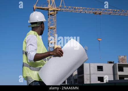 African American architect compares building to drawings Stock Photo