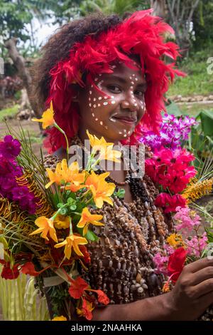 Village girls in tapa bark cloth dresses preparing to perform traditional sing sing Melanesian tribal dance in Natade Village in the Tufi Fjords of Ca Stock Photo