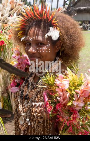 Village girls in tapa bark cloth dresses preparing to perform traditional sing sing Melanesian tribal dance in Natade Village in the Tufi Fjords of Ca Stock Photo