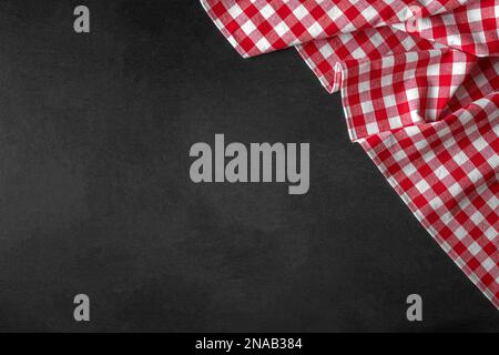 Checkered tablecloth on a black background. Stock Photo