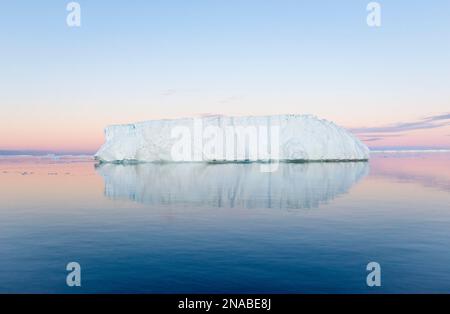 A tabular iceberg under the midnight sun of the Antarctic summer in the Weddell Sea, Antarctic Sound, Antarctica. Stock Photo