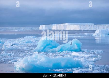 Tabular icebergs under the midnight sun of the Antarctic summer in the Weddell Sea, Antarctic Sound, Antarctica. Stock Photo