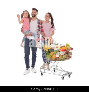 Happy family with shopping cart full of groceries on white background Stock Photo
