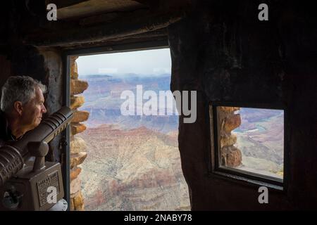 Tourist at Desert View Watchtower looks out at the Grand Canyon in Arizona, USA; Arizona, United States of America Stock Photo
