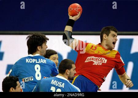 Spain's Julen Aguinagalde, right, shoots and scores past Croatia's Marko Kopljar, left, and Croatia's Zeljko Musa, center, during their Men's European Handball Championship bronze medal match in Belgrade, Serbia, Sunday, Jan. 29, 2012. (AP Photo/Marko Drobnjakovic)