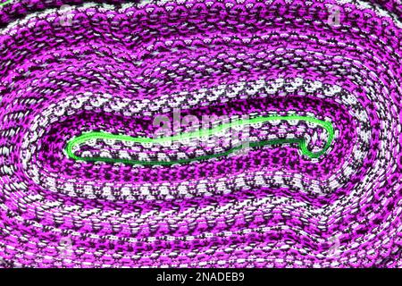 Vibrant purple colored curving lined of rolled up Peruvian fabric for sale in downtown Cuzco, Peru, South America Stock Photo