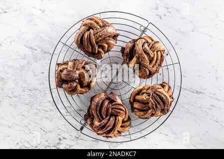 Freshly baked, caramel-cinnamon buns on the kitchen grill - Top of view. Stock Photo