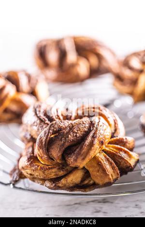 Freshly baked, caramel-cinnamon buns on the kitchen grill. Stock Photo