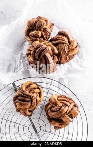 Freshly baked, caramel-cinnamon buns on the kitchen grill - Top of view. Stock Photo
