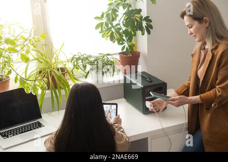 The inverter generator charges the power bank battery Stock Photo