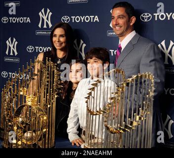 ADDS NAME OF MOTHER - Former New York Yankees catcher Jorge Posada, second  from right, and his wife Laura Posada, third from left, wave to fans while  standing inside Monument Park with