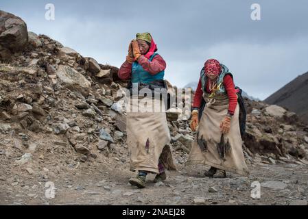 Pilgrims starting on the Kora pilgrimage and prostrating on Mount Kailash; Tibetan Autonomous Region, Tibet Stock Photo
