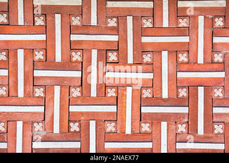 Texture of a wall covered with decorative brick-like tiles. Abstract background for design. Stock Photo