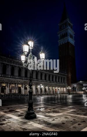 Illuminated ornate street lamps in St Marks square, Venice. Stock Photo