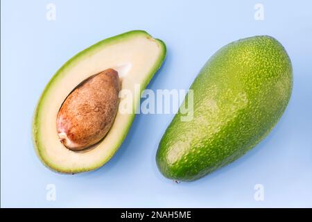 Fresh avocado close up isolated on blue background, diet food Stock Photo