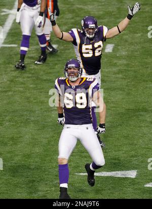 Minnesota Vikings Chad Greenway celebrates his 37 yard interception return  for a touchdown against the New York Giants in the fourth quarter with  teammates E.J. Henderson (56) and Ben Leber (51) at