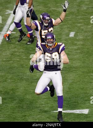 Minnesota Vikings Chad Greenway celebrates his 37 yard interception return  for a touchdown against the New York Giants in the fourth quarter with  teammates E.J. Henderson (56) and Ben Leber (51) at