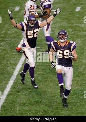 Minnesota Vikings Chad Greenway celebrates his 37 yard interception return  for a touchdown against the New York Giants in the fourth quarter with  teammates E.J. Henderson (56) and Ben Leber (51) at