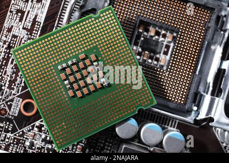 Computer motherboard with processor microchip as background, top view. Electronic device Stock Photo