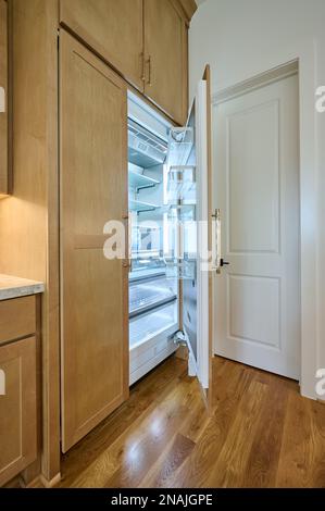 Open Refrigerator Door in Contemporary Kitchen Built In Cabinetry Stock Photo