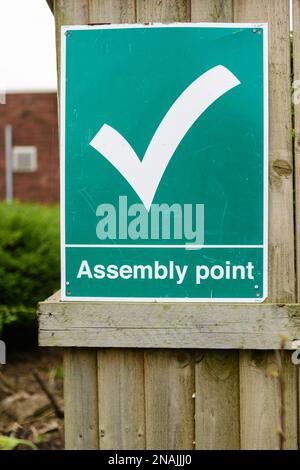 A fire assembly point sign indicates the rendezvous point in case of ...