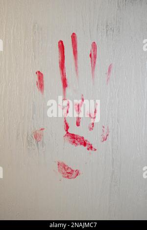 blood smeared bloody handprint on frosted glass window or shower screen Stock Photo