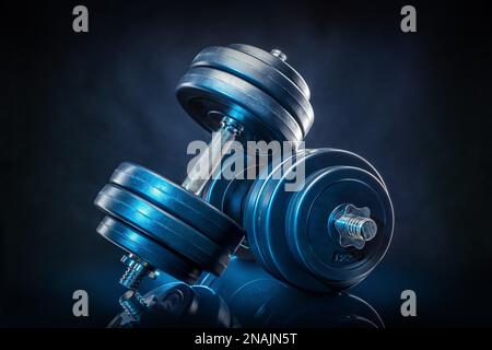 dumb bells against a black background Stock Photo