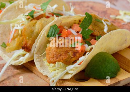 Baja California style fish tacos with toppings and salsas. Ensenada style tacos Stock Photo