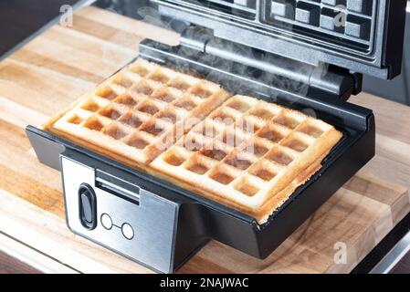 high angle view of preparing homemade belgian waffles in waffle maker Stock Photo