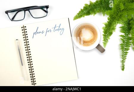 open spiral notebook with handwritten text PLANS FOR TODAY, pen and glasses on white table background Stock Photo